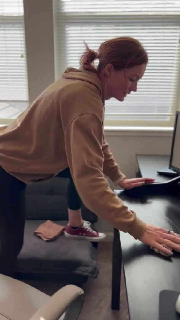 Just a housewife cleaning while hiding something underneath.
