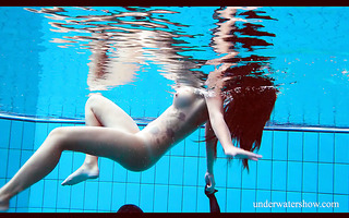 Playful Nata swims in a pool in nice dress and fleshing her nice booty