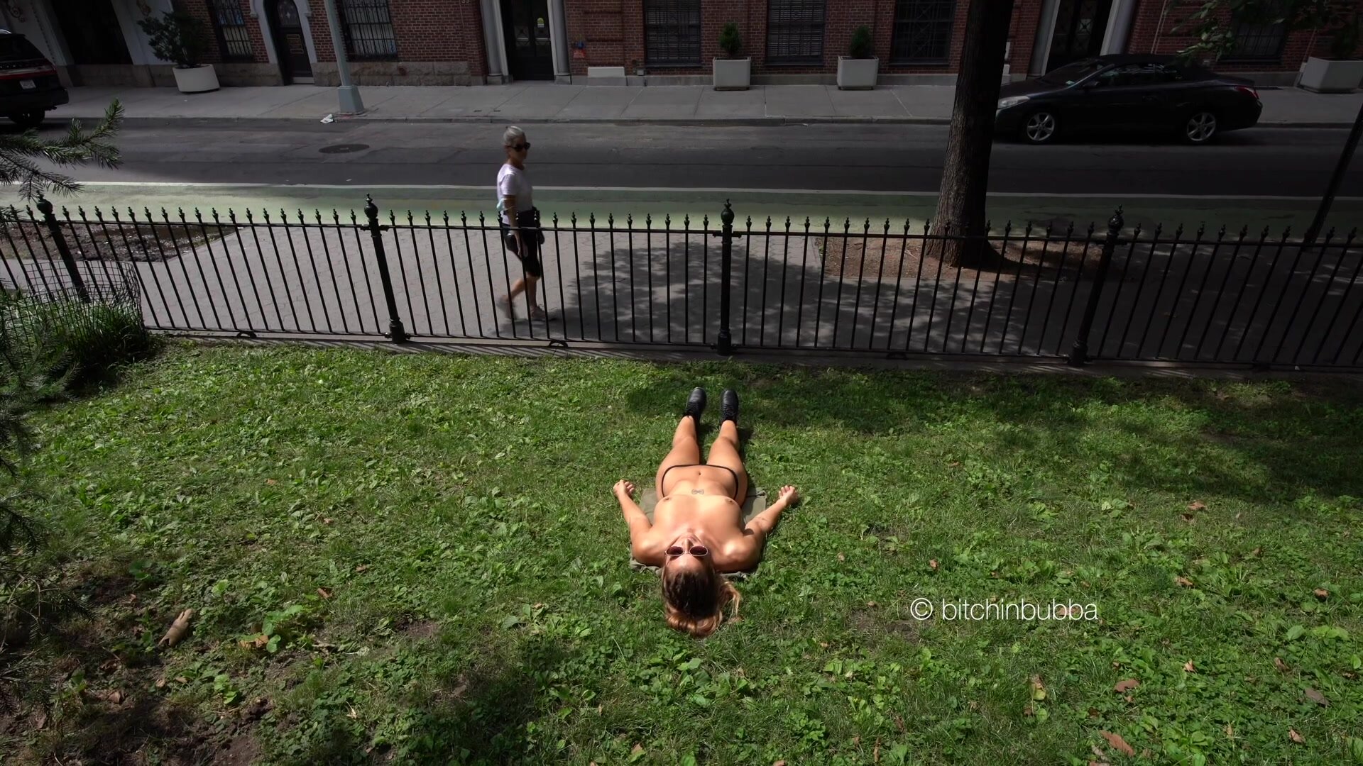 Sun tanning next to a busy street